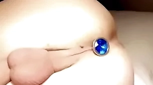 Twink with niggardly balls puts butt plug near niggardly hole