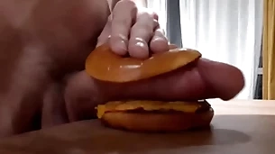 Muscular sizzling teen fucks a burger with a big gumshoe and cums close by it